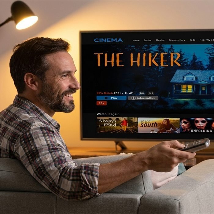 Man streaming a movie on a Smart TV in his living room using an IPTV app